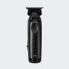 Black hair trimmer shown from the front, featuring a textured grip, side buttons, and a visible 'BabylissPro' logo near the top, set against a solid light gray background.