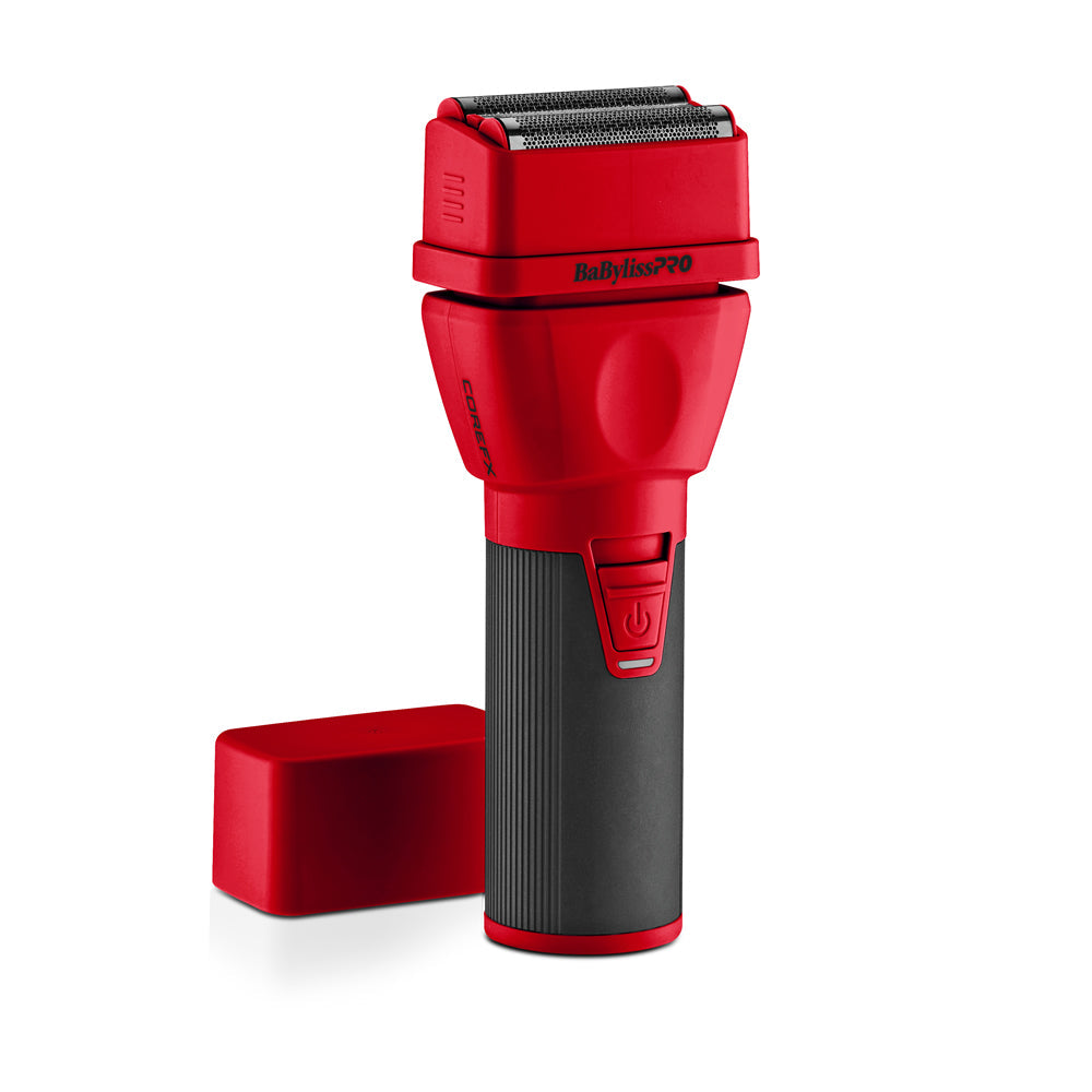 A red and black BabylissPro 900 electric shaver with its matching red protective cap placed beside it on a clean white background.