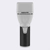 A BaBylissPRO handheld electric shaver shown vertically against a light gray background. The device features a white plastic head and upper body, a textured black grip, and a silver power button on the front.