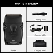 Box contents graphic for a BabylissPRO shaver, showing the black shaver, a cleaning brush, a charging cable with charger, and a charging stand, with the heading 'WHAT'S IN THE BOX'.