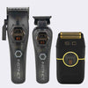 Two black grooming devices and a matching black charging case on a light gray background. The devices have metallic silver and gold accents, and the case features gold detailing around the charging contact area.