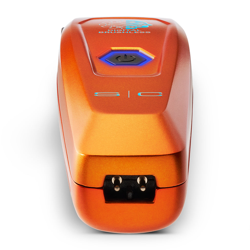 An orange metallic electronic device with a blue and black power button on top, featuring the text 's|c business' on the front, set against a plain white background.