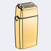 A metallic gold BaBylissPRO electric shaver with a black side strap and silver blade heads, shown on a light gray background.