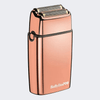 A BaBylissPRO electric shaver in a metallic rose gold finish, shown from a three-quarter angle against a light gray background.