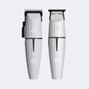 Two silver hair trimmers with digital display on a white background